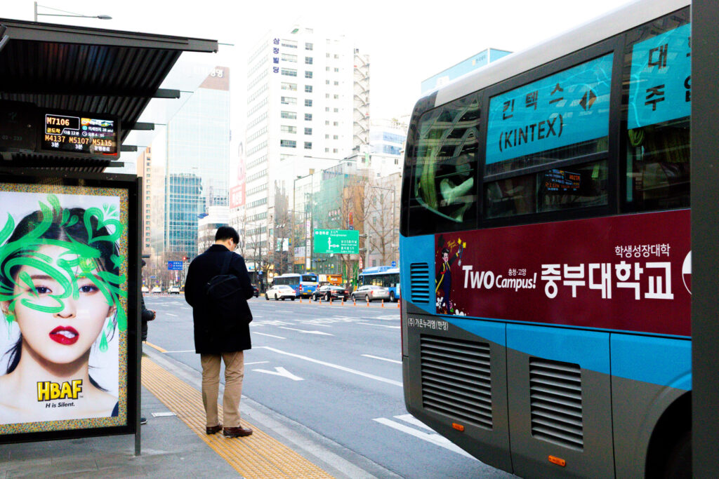 Street Photography by Photographer Donald MacDonell.
Color Street Photo with Bus stop sign